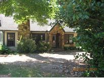 Charming stone and frame home with mature landscaping at 960 Stone Mountain Lithonia Rd, Lithonia, GA 30058
