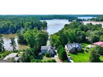 Aerial view of lakefront property with two houses at 395 Lang Rd, Covington, GA 30014