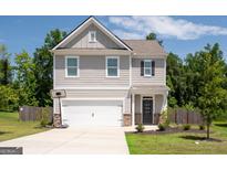 Two-story house with gray siding, white garage door, and a basketball hoop at 6904 Oak Valley Dr, Douglasville, GA 30134