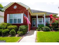 Brick ranch home with front porch and landscaped yard at 110 Emily Park, Fayetteville, GA 30215