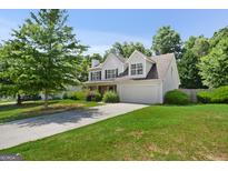 Two-story home with a two car garage and well manicured lawn at 3463 Madison Farm Way, Snellville, GA 30039