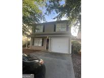 Two story house with attached garage and landscaping at 449 Kara Ln, Mcdonough, GA 30253