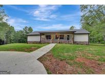 Ranch home with stone accents and a covered porch at 2752 Poplar Rd, Sharpsburg, GA 30277