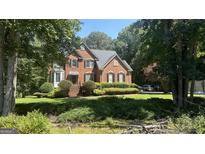 Brick house exterior with lush landscaping and driveway at 185 Pointer Ridge Trl, Fayetteville, GA 30214