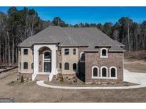 Two-story brick house with a large driveway at 230 Waltham Way, Fayetteville, GA 30214
