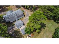 Aerial view of house, detached garage, and expansive green space at 1072 Harbins Rd, Dacula, GA 30019