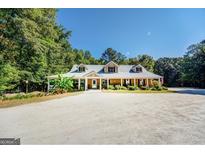 House exterior showcasing wrap-around porch and landscaping at 371 Oakland Rd, Mcdonough, GA 30253