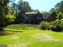 Two story house with stone accents and a large yard at 1145 Lake Stone Lea Dr, Oxford, GA 30054