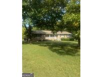 Ranch-style home with front porch and lawn at 1112 Harbins Rd, Dacula, GA 30019