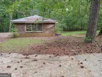 Brick home exterior with a small yard and pine needles at 4480 Old Fairburn Rd, South Fulton, GA 30349