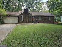Brick ranch house with attached garage and lawn at 2531 Quentin Dr, Jonesboro, GA 30236