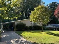 Charming ranch home with a well-maintained lawn and driveway at 2213 Westover Dr, East Point, GA 30344