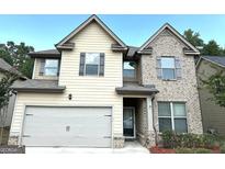 Two-story house with a large garage and brick facade at 700 Emporia Loop, Mcdonough, GA 30253