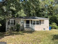 Brick ranch home with mature trees and front yard at 245 Argus Nw Cir, Atlanta, GA 30331