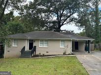 Front view of ranch house with carport and lawn at 2311 Amber Way, Decatur, GA 30032