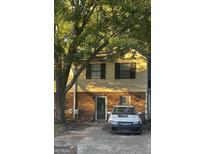 Brick townhouse exterior with a car parked in the driveway at 2254 Salt Springs Pl, Austell, GA 30168