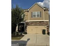 Two-story house with neutral siding, stone accents, and a two-car garage at 844 Venture Sw Way, Atlanta, GA 30331