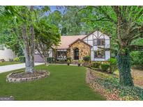 Two-story house with stone accents and a manicured lawn at 3142 Brooks Dr, Snellville, GA 30078