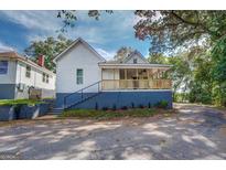 Charming house with a porch, new paint, and landscaping at 2 Poplar St, Porterdale, GA 30070