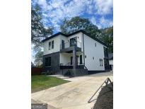 Modern two-story home with gray brick and white siding at 3419 Hamilton Ave, Hapeville, GA 30354