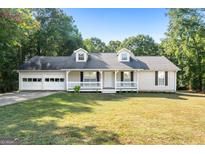 Ranch style home with attached garage and landscaped yard at 125 Laney Ct, Mcdonough, GA 30252