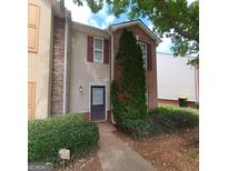 Brick front townhouse with a well-maintained landscaping at 2103 Grove Way, Hampton, GA 30228