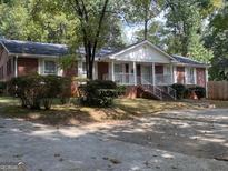 Brick ranch house with attached garage and landscaping at 4850 Lehigh Dr, Douglasville, GA 30135