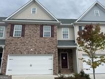 Brick townhouse with a two-car garage and a charming facade at 2960 Fareed St, Douglasville, GA 30135