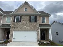 Brick front of two-story townhome with attached garage at 2721 Fareed St, Douglasville, GA 30135