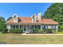 Charming two-story house with a copper roof and green shutters at 115 Worthy Dr, Mcdonough, GA 30252