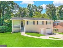 Ranch style home with attached two-car garage at 1863 Rollingwood Se Dr, Atlanta, GA 30316