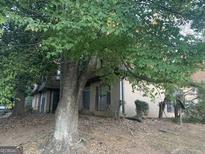 Two-story home with partial exterior view, large tree, and landscaping at 2914 Parc Lorraine, Stonecrest, GA 30038