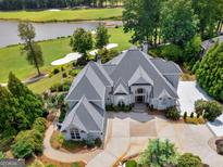 Luxury home on golf course with large backyard and circular driveway at 115 Eagles Club Dr, Stockbridge, GA 30281