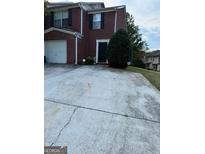 Brick townhouse with attached garage and private driveway at 2237 Wind Rose Ct, Lithonia, GA 30058