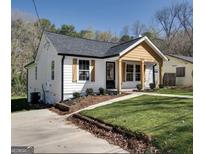 Charming craftsman style home with a landscaped lawn and front porch at 2029 Detroit Nw Ave, Atlanta, GA 30314