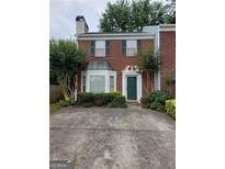 Charming two-story brick home with a green door and landscaped front yard at 679 Anderson Walk, Marietta, GA 30062