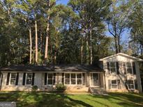 Ranch-style home with a large yard and mature trees at 4330 Cedar Valley Ln, Conley, GA 30288