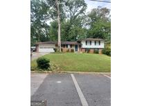 Ranch style house with attached garage and mature trees at 1999 Lindsey Ln, Decatur, GA 30035