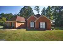 Brick ranch house with well-maintained landscaping at 50 Lydia Ct, Covington, GA 30016