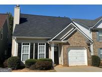 Brick and siding townhouse with a garage at 9585 Lakeview Cir, Union City, GA 30291