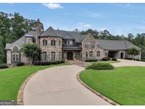 Luxury home with stone exterior and circular driveway at 616 Elliott Rd, Mcdonough, GA 30252