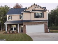 Two-story house with tan siding and a white garage door at 200 Parker Dr, Mcdonough, GA 30253