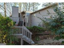 Gray two-story house with wooden deck and stairs at 5260 Island Dr, Stone Mountain, GA 30087