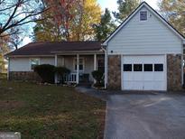Ranch style home with attached garage and landscaped yard at 9388 Crest Knoll Ct, Jonesboro, GA 30238