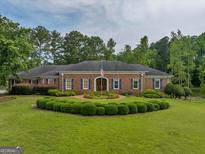 Brick ranch home with manicured landscaping at 655 Mcdonough Rd, Hampton, GA 30228