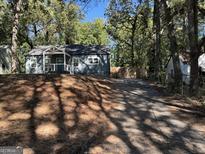 Newly renovated blue house with a driveway at 1901 Maywood Nw Pl, Atlanta, GA 30318