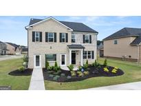 Two-story house with stone and brick facade, landscaping, and double doors at 644 Edgar # 162, Hampton, GA 30228