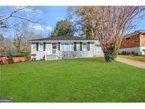 Charming ranch home with gray exterior, updated windows, and a manicured lawn at 2164 Rockhaven Cir, Decatur, GA 30032