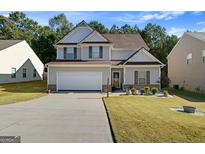 Two-story house with front yard and driveway at 6494 Saint Mark Way, Fairburn, GA 30213