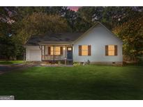 Charming one-story home with front porch and lawn at 355 E Anderson Rd, Locust Grove, GA 30248